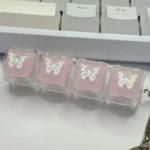 Ethereal pink butterfly resin keycap, handcrafted with shimmering glitter, showcasing a translucent design for a dreamy keyboard.