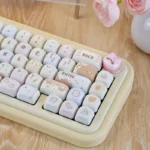 A playful Sweet Treat MOA PBT Cake keycap set, showcasing its adorable cream design and unique MOA profile from various angles.