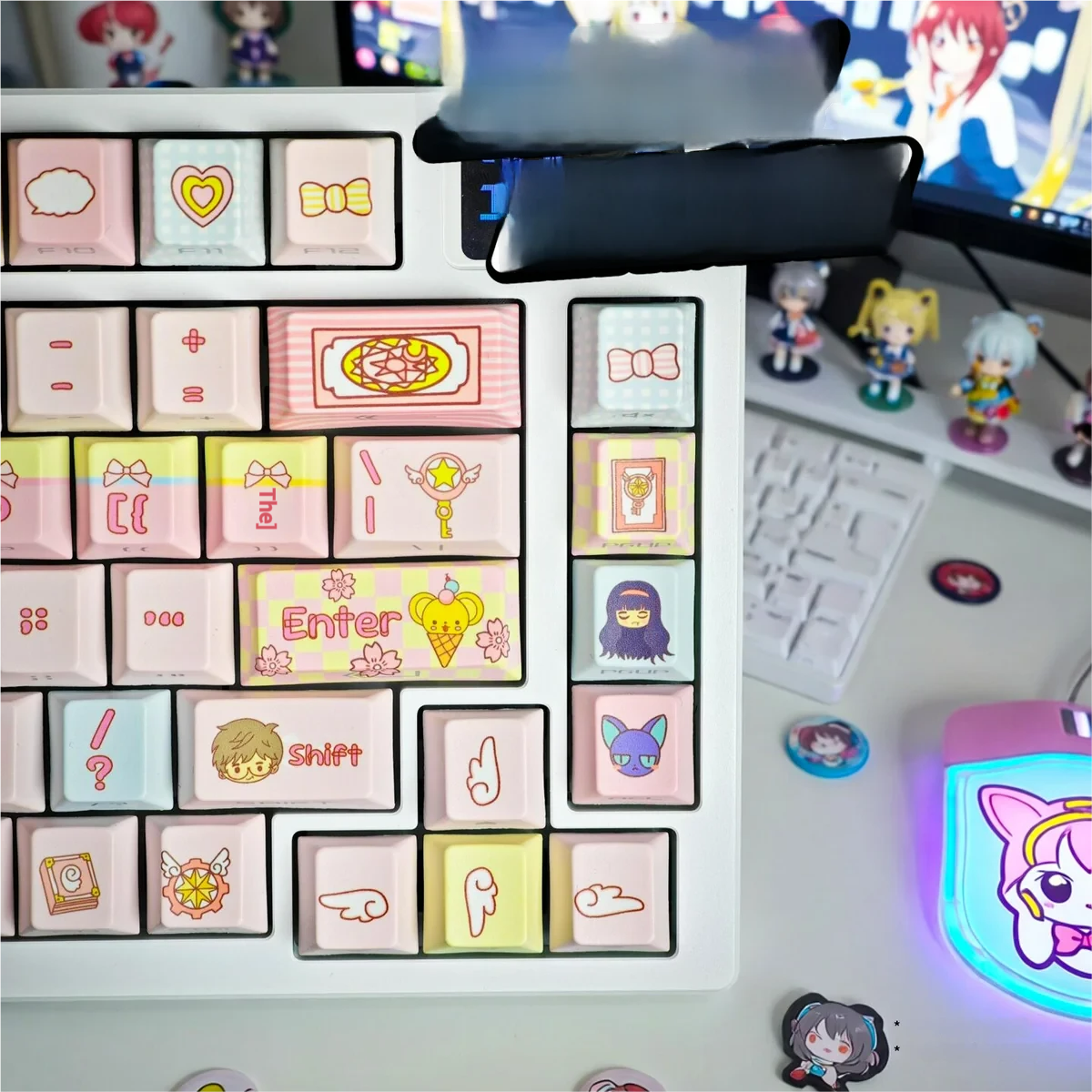 Close-up of Cardcaptor Sakura & friends keycaps set, showcasing vibrant pink and gold magical girl anime motifs from an appealing angle. An iconic keyboard set.