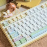 Whimsical Cat Fishing PBT Dye-Sub Keycaps set, charmingly designed with playful cartoon cats, shown from various angles for a serene desktop.