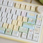 Whimsical Cat Fishing PBT Dye-Sub keycaps set, displayed from multiple angles. Charming cartoon cats fishing on tranquil waters for a playful desktop.