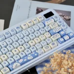 Close-up of the unique Ocean Serenity PBT MOA Sea Salt Cat Keycap Set, showcasing playful kitten art, calm blue tones, and tranquil ocean aesthetic.