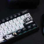 Vibrant close-up of a PBT keycap set, showcasing dynamic anime art of Kobeni Higashiyama from the exclusive Chainsaw Man keycaps collection.