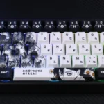 An artistic view of the exclusive Kobeni's Charm Chainsaw Man PBT keycaps set, featuring vibrant, character-driven anime art of Kobeni Higashiyama.