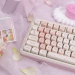 Elegant cherry blossom PBT MOA profile keycaps set displayed from various angles, highlighting the delicate pink motifs and durable, serene design.