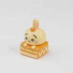Close-up views of the adorable Chiikawa dessert pie artisan keycap for ESC, showcasing its charming miniature design and vibrant colors from multiple angles.