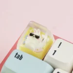 Whimsical handcrafted Chiikawa keycap. Adorable resin characters with expressive details are shown from multiple angles, a charming desk accent.