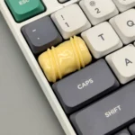 Handcrafted artisan chocolate keycap, made from smooth resin with rich chocolate and caramel swirls. This delectable accessory is shown from various angles.