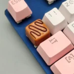 Artisan chocolate resin keycap in striped caramel, evoking a sweet dessert for your mechanical keyboard. Handcrafted with warm, inviting textures.