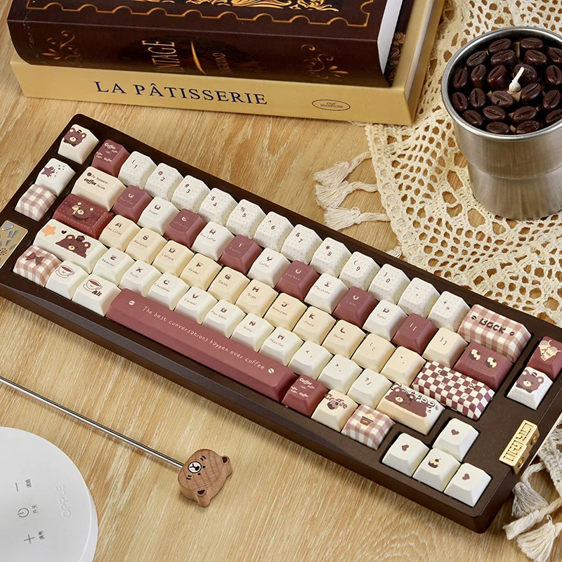 Adorable PBT dye-sublimated coffee bear keycap set, showcasing a charming cartoon character in warm, earthy tones for whimsical keyboard coziness.