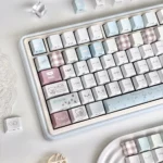 Collage Mood Keycap Set, artistic collage design, highlighting its unique side-lit translucent legends from a detailed angle.
