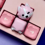 Close-up of adorable hand-painted resin Corgi butt keycaps in soft pink, highlighting the whimsical design and artisan craftsmanship.