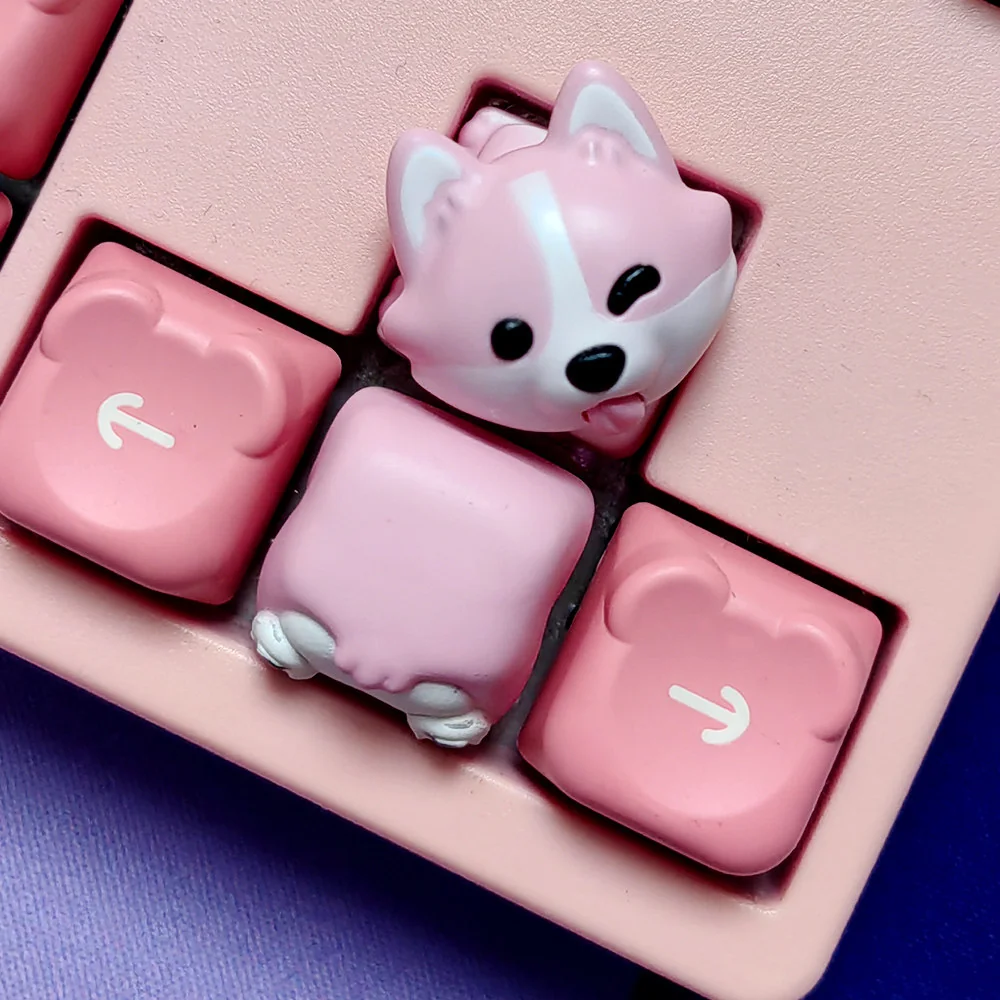 Close-up of adorable hand-painted resin Corgi butt keycaps in soft pink, highlighting the whimsical design and artisan craftsmanship.