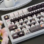 Whimsical Cow Cat keycap set from various angles, highlighting its unique black and white cow pattern as a charming artisan novelty for mechanical keyboard.