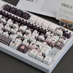 Adorable cow cat keycap set from various angles, showcasing the unique black and white design for mechanical keyboards. This whimsical artisan novelty.