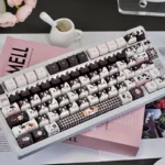 Adorable Whimsical Cow Cat Keycap Set, a unique artisan for mechanical keyboards, featuring a charming black and white cow-patterned cat head.