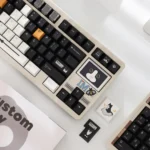 Artistic Cow Cat PBT keycaps set, a distinctive black and white set for custom keyboards, displayed from multiple angles to highlight unique designs.