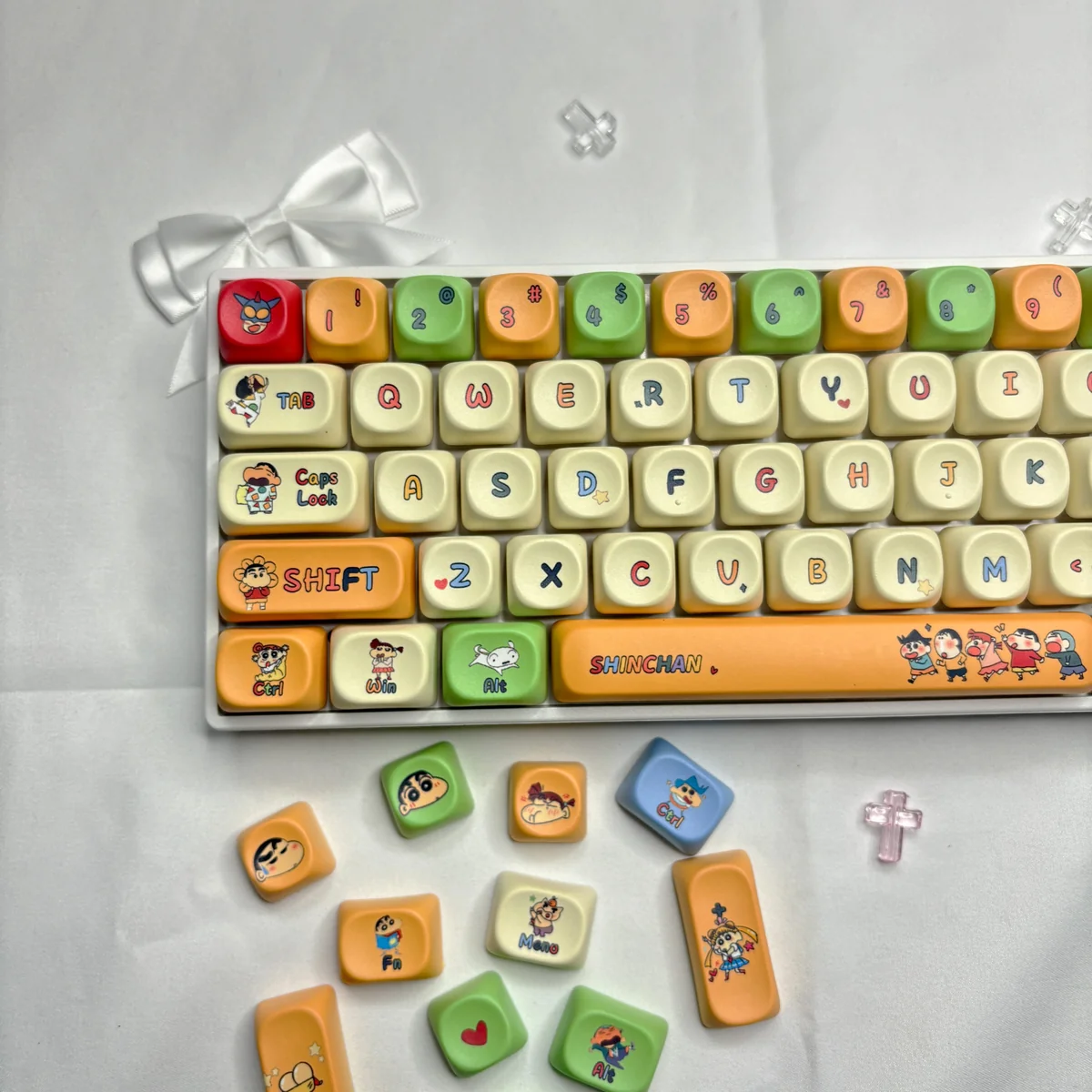 Vibrant Crayon Shin-chan MOA keycap set, shown from a playful angle, highlighting iconic characters and durable dye-sub PBT for whimsical keyboard design.