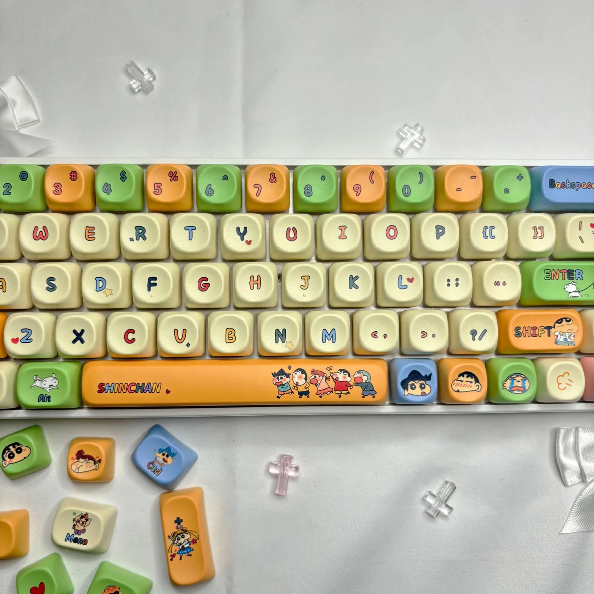Playful Crayon Shin-chan MOA keycap set with vibrant characters and scenes on durable dye-sub PBT caps, viewed from multiple angles.
