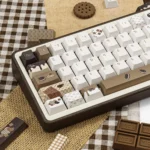 Crispy Dark Chocolate PBT keycaps set, shown from various angles, highlighting their unique dark textured aesthetic. An artistic gourmet chocolate motifs.