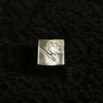 Detailed side view of a premium CSGO keycap, showcasing its authentic metallic replica design and intricate craftsmanship. This artisan art piece.