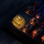 A close-up view of the premium CSGO Team Vitality backlit ESC keycap, showcasing its luminous hollow bee logo and sleek gaming design from multiple angle.