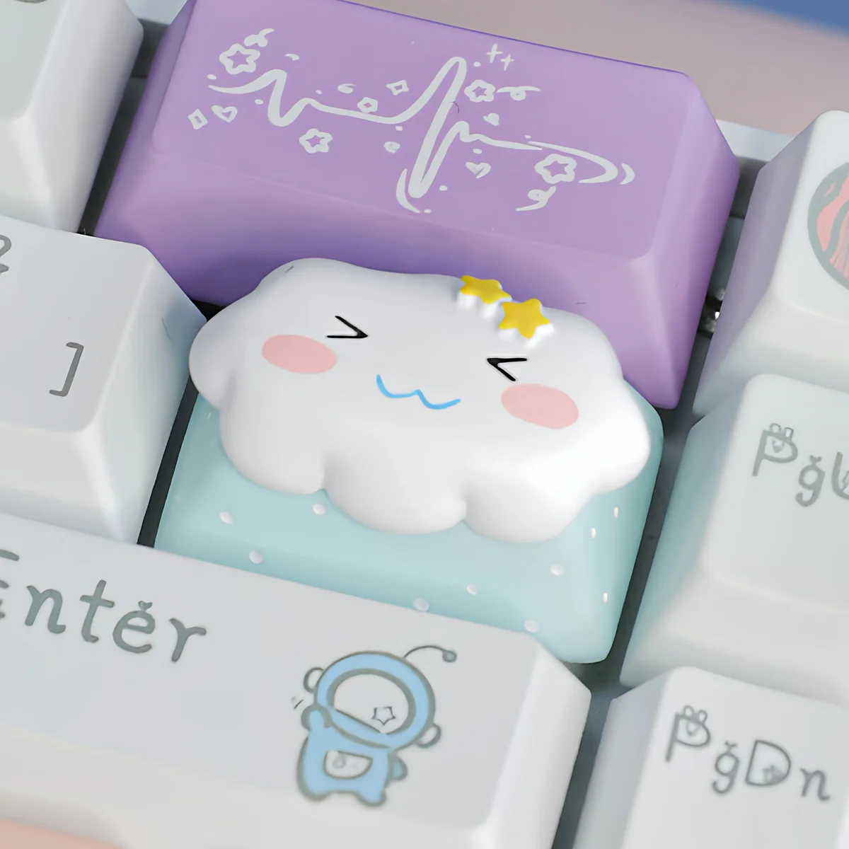 Close-up of a Cute Cloud & Star Artisan Keycap, showcasing its unique design with a detailed cosmic floating in vibrant cloud and star design.