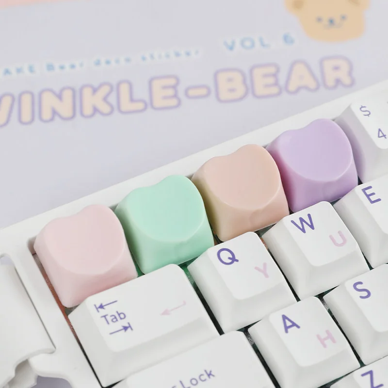 Close-up of a cute pastel hues heart keycap for the ESC key, showcasing its adorable design, adding a playful and personalized charm to your keyboard.