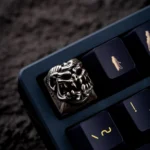 Close-up, angled shot of the handcrafted Disaster Relief Demon Keycaps, revealing its intricate metallic texture and dark industrial details.