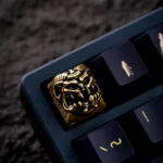 Handcrafted Disaster Relief Demon Keycaps, showcasing its intricate metallic details and dark industrial aesthetic from a striking new angle.