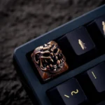 Artistic handcrafted Disaster Relief Demon Keycaps, featuring a defiant copper finish with intricate metallic industrial details.
