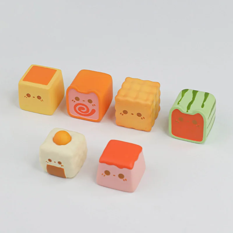 Close-up of a handcrafted egg yolk onigiri artisan keycap, showing its adorable miniature details and vibrant color.