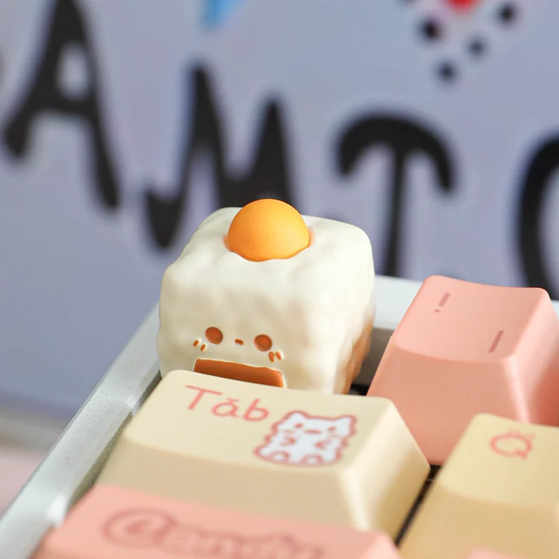 Detailed shot of the handcrafted egg yolk onigiri artisan keycap, showcasing its adorable miniature design and vibrant colors from a playful, unique design.