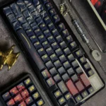 Product gallery view of the exclusive Elden Ring Malenia keycaps set, highlighting intricate dark fantasy artistry and semi-translucent details from various angle.