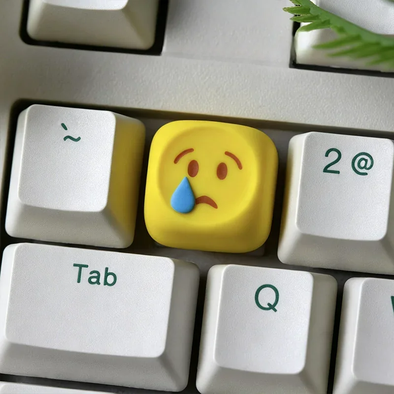 Close-up views of several playful handcrafted resin emoji keycaps, highlighting their vibrant expressions and glossy finish for custom ESC personalized.