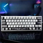 Close-up of the Fallen Angel metallic Paint Artistry keycap set, revealing its dark, ethereal design and striking metallic paint finish from an oblique angle.