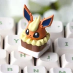 A vibrant, whimsical artisan Flareon cake keycap, showcasing a detailed Pokemon dessert theme for your ESC keyboard. Unique and playful.