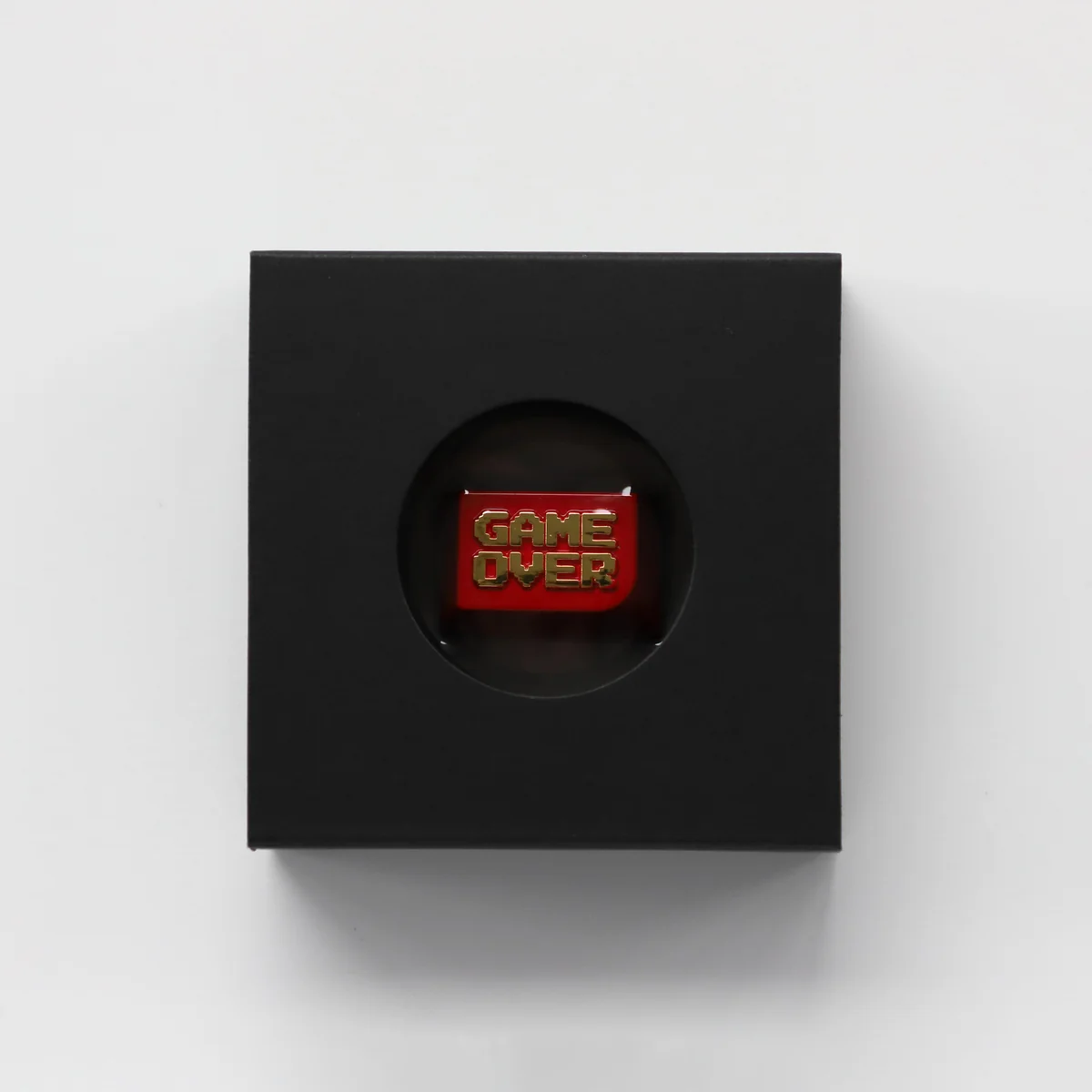 This premium zinc alloy Game Over keycap gallery image highlights its bold red and gold metallic finish and clear iconic lettering from various angle.