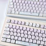 Whimsical translucent PBT Ghost Haha keycaps set in an ethereal design, showcasing their playful design and dreamy glow from a unique angle.