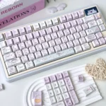 Close-up gallery view of whimsical translucent PBT Ghost Haha keycaps set, featuring their ethereal light purple glow and playful design from all sides.
