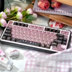 Close-up of vibrant transparent PC black pink graffiti keycaps set, showcasing edgy street art design and translucent material from a unique angle.