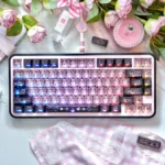 Vibrant transparent PC black pink graffiti keycap set displayed, showcasing edgy street art design and translucent aesthetics.
