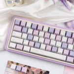 Close-up of the indulgent Grape Mousse PBT Dye-Sub Keycap Set, showcasing its soft hues from multiple angles, evoking a luxurious design.