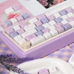 Grape Mousse PBT Dye-Sub Keycap Set, showcasing its soft hues from a unique angle, an indulgent and premium desk accessory.