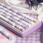Premium Grape Mousse PBT Dye-Sub Keycap Set, artfully angled. Soft hues evoke luxurious dessert mousse, highlighting its indulgent design.