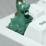 Whimsical Green Meadow Handcrafted Green Pony Keycap, an artisan resin piece, viewed from a delightful angle, showcasing its lush green hues and intricated design.