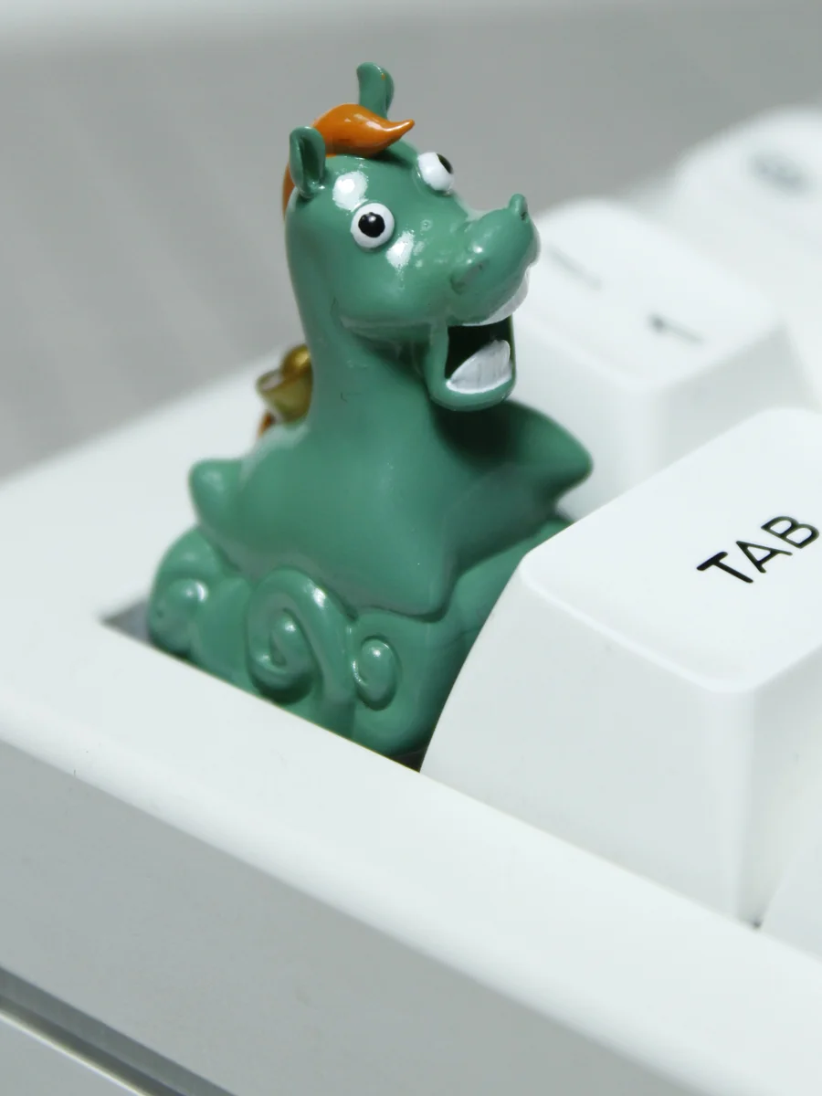 Whimsical Green Meadow Handcrafted Green Pony Keycap, an artisan resin piece, viewed from a delightful angle, showcasing its lush green hues and intricated design.