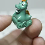 Artistic close-up of the whimsical handcrafted resin green pony keycap, revealing lush meadow details and enchanting pastoral charm from a fresh angle.