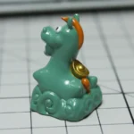 Handcrafted resin green pony keycap from a unique angle, revealing whimsical details and lush green meadow design, adding enchanting pastoral charm.