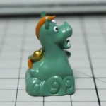 Handcrafted resin Whimsical Green Pony Keycap from a different angle, showcasing its artisan details and lush green meadow design. An enchanting desktop.